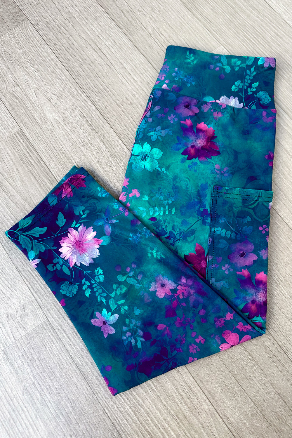 Floral-patterned leggings on a wooden floor
