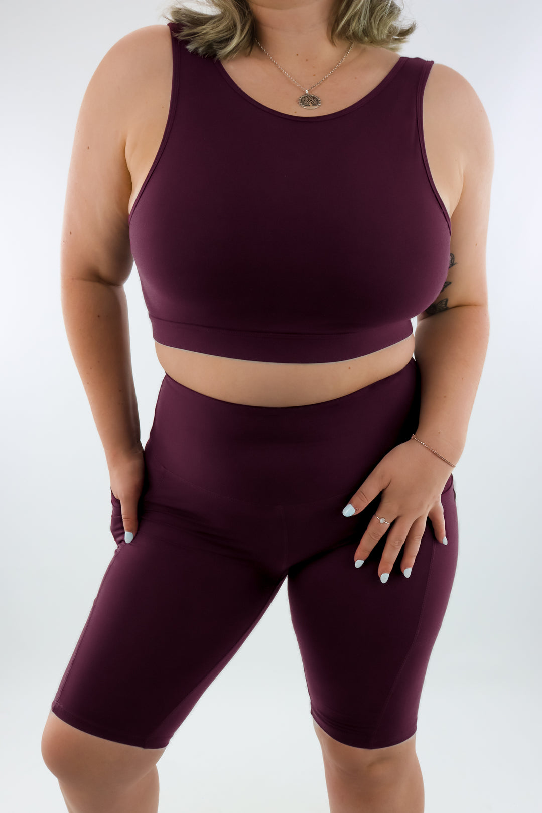 Person wearing a maroon athletic outfit on a white background