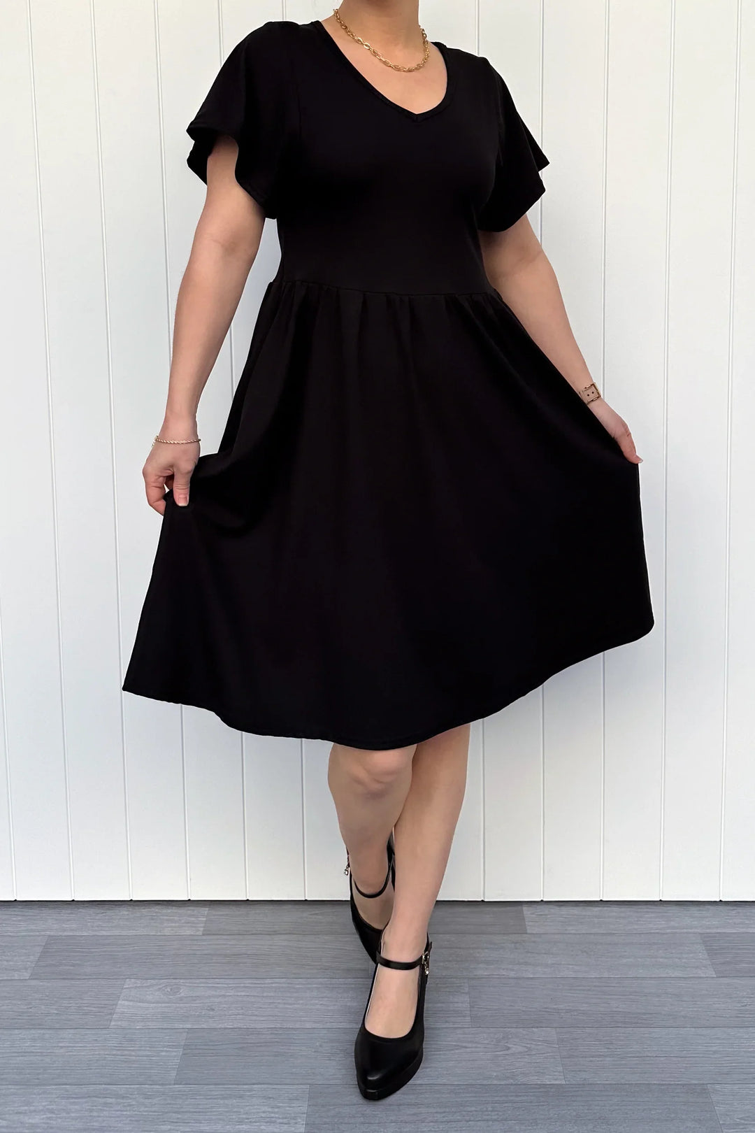 Knee-Length Black Dress with Pockets - Feminine Flutter Sleeves Pawlie Knee-Length Black Dress with Pockets - Feminine Flutter Sleeves Pawlie